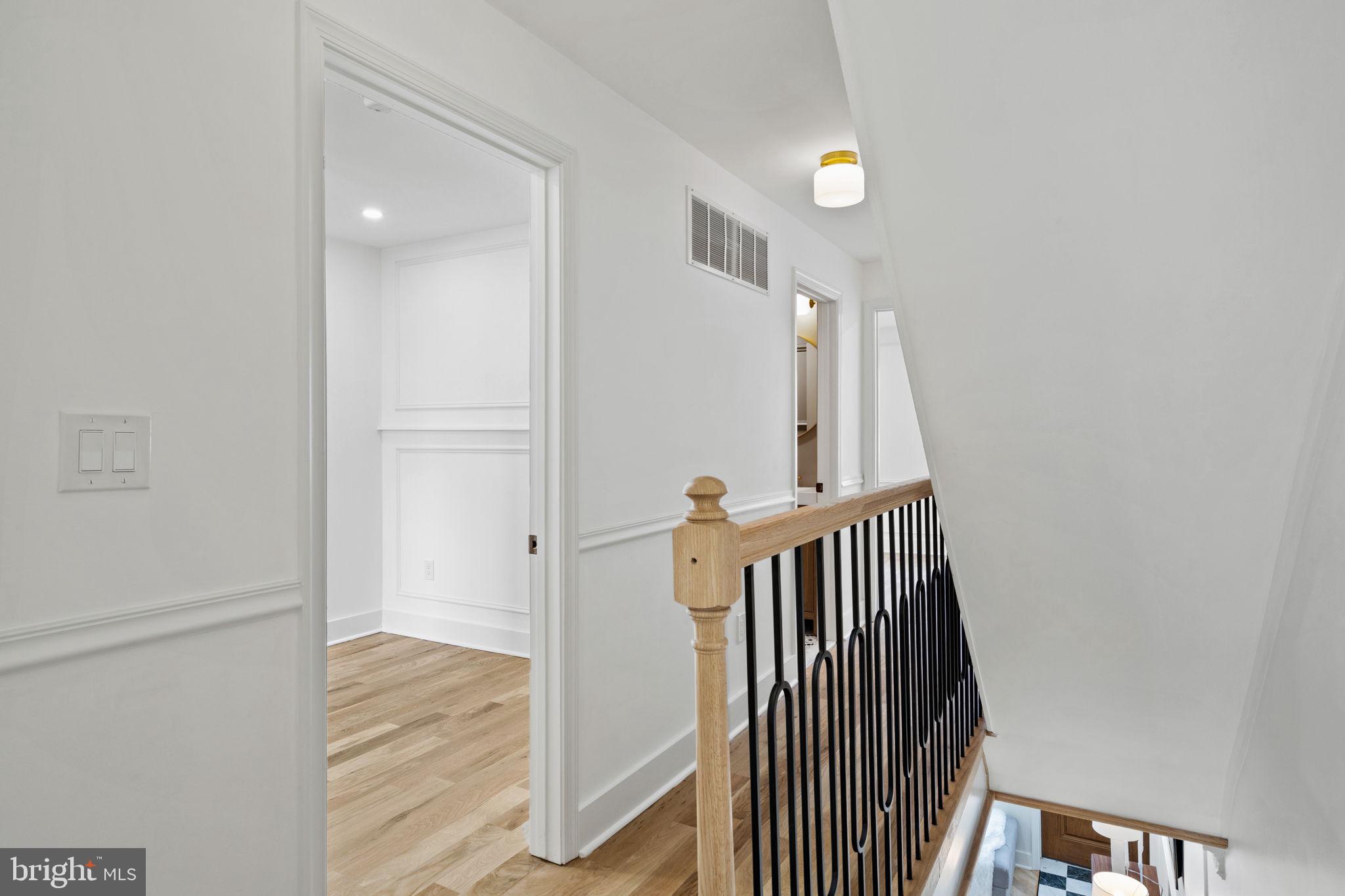 914 Fernon Street Philadelphia, PA 19148 - Photo 17 of 40 a view of a hallway with wooden floor and staircase