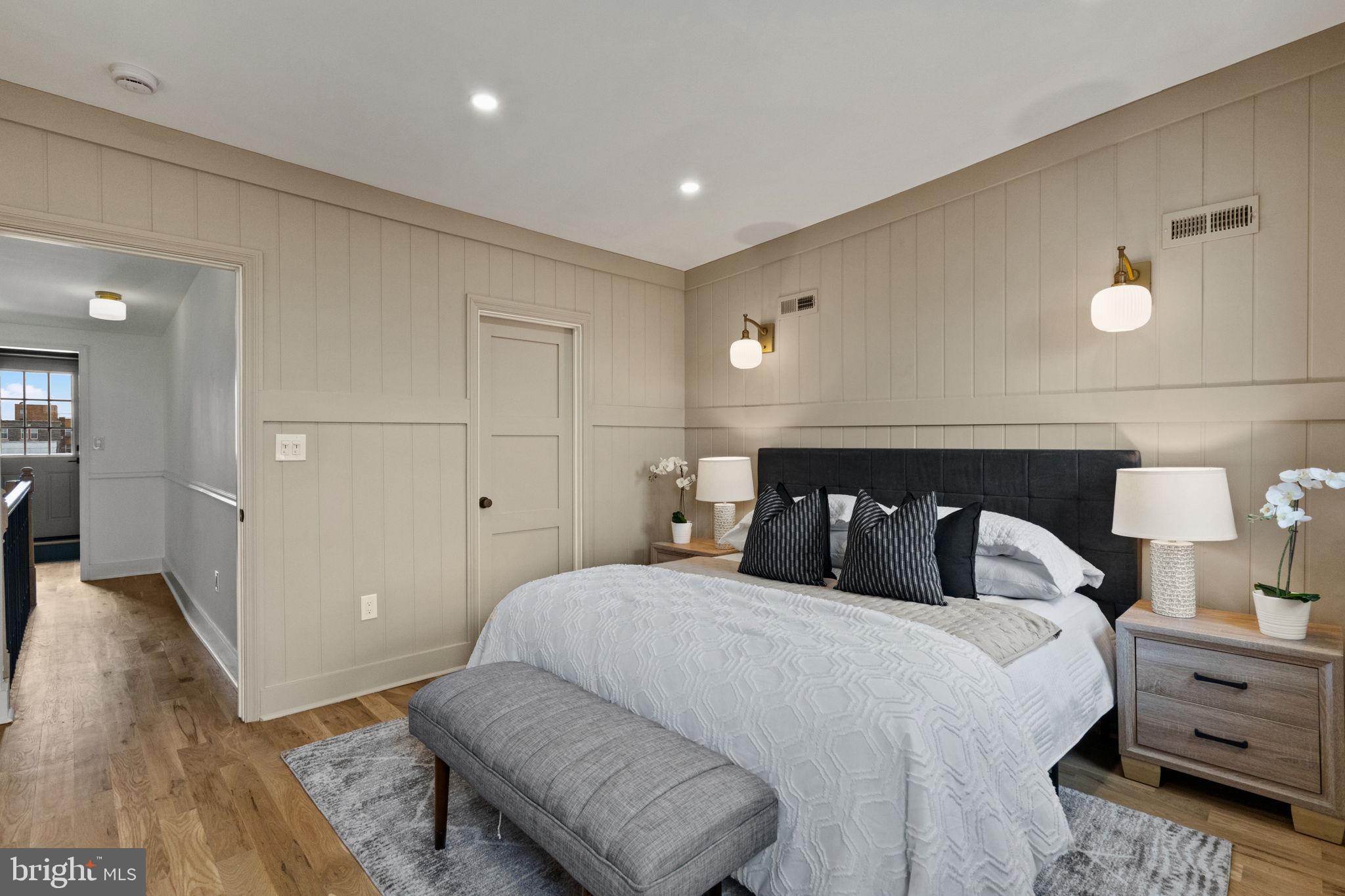 914 Fernon Street Philadelphia, PA 19148 - Photo 26 of 40 a bedroom with a bed and wooden floor