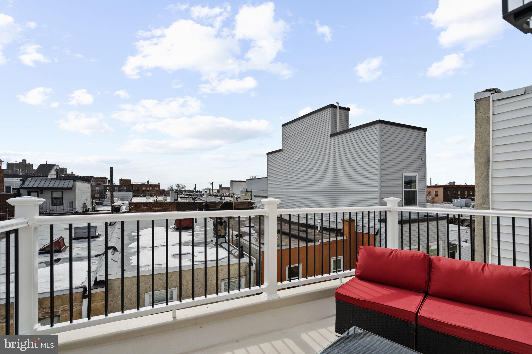 914 Fernon Street Philadelphia, PA 19148 - Photo 33 of 40 a roof deck with a couch and wooden floor