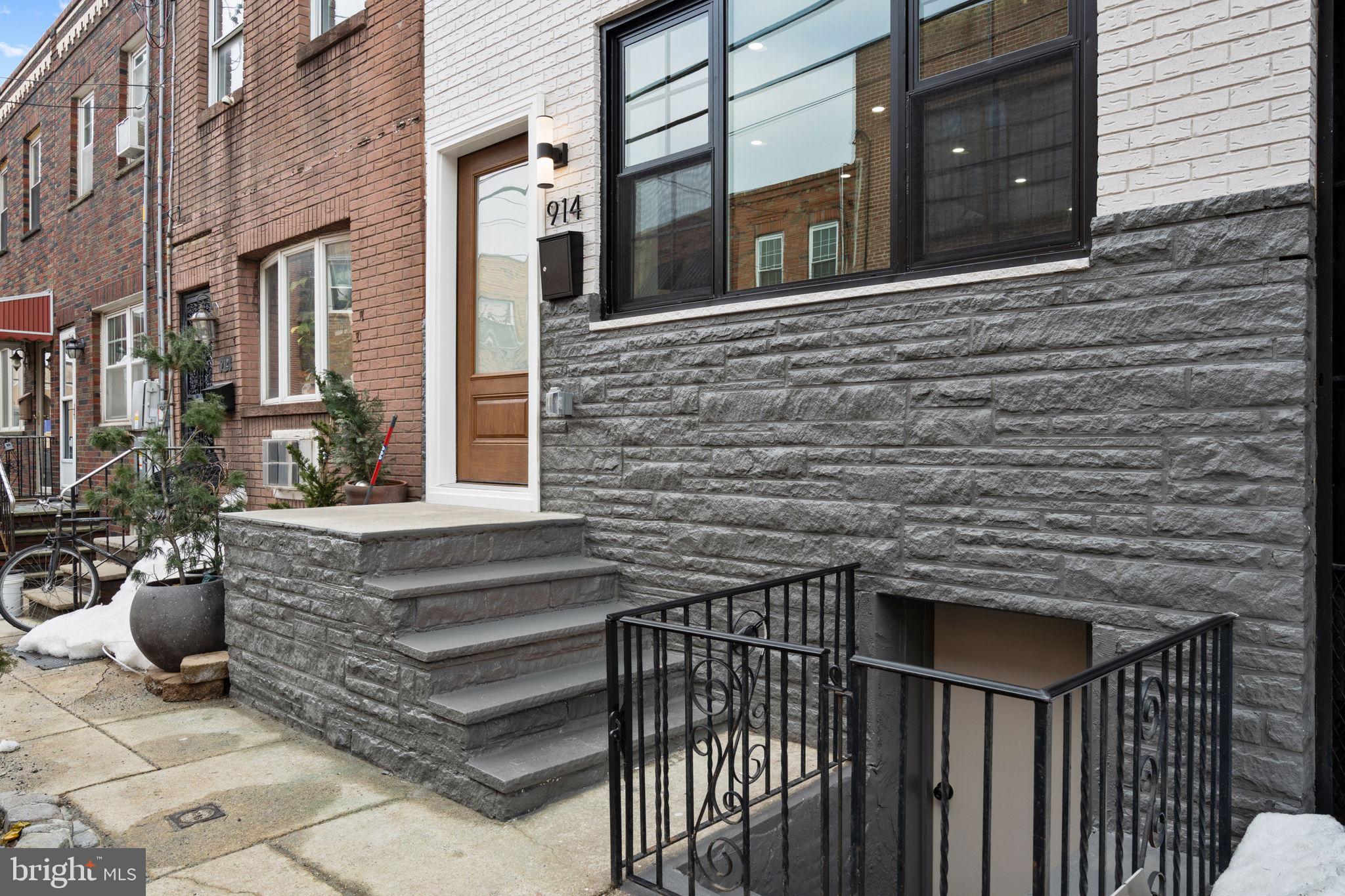 914 Fernon Street Philadelphia, PA 19148 - Photo 39 of 40 a view of a brick house with many windows