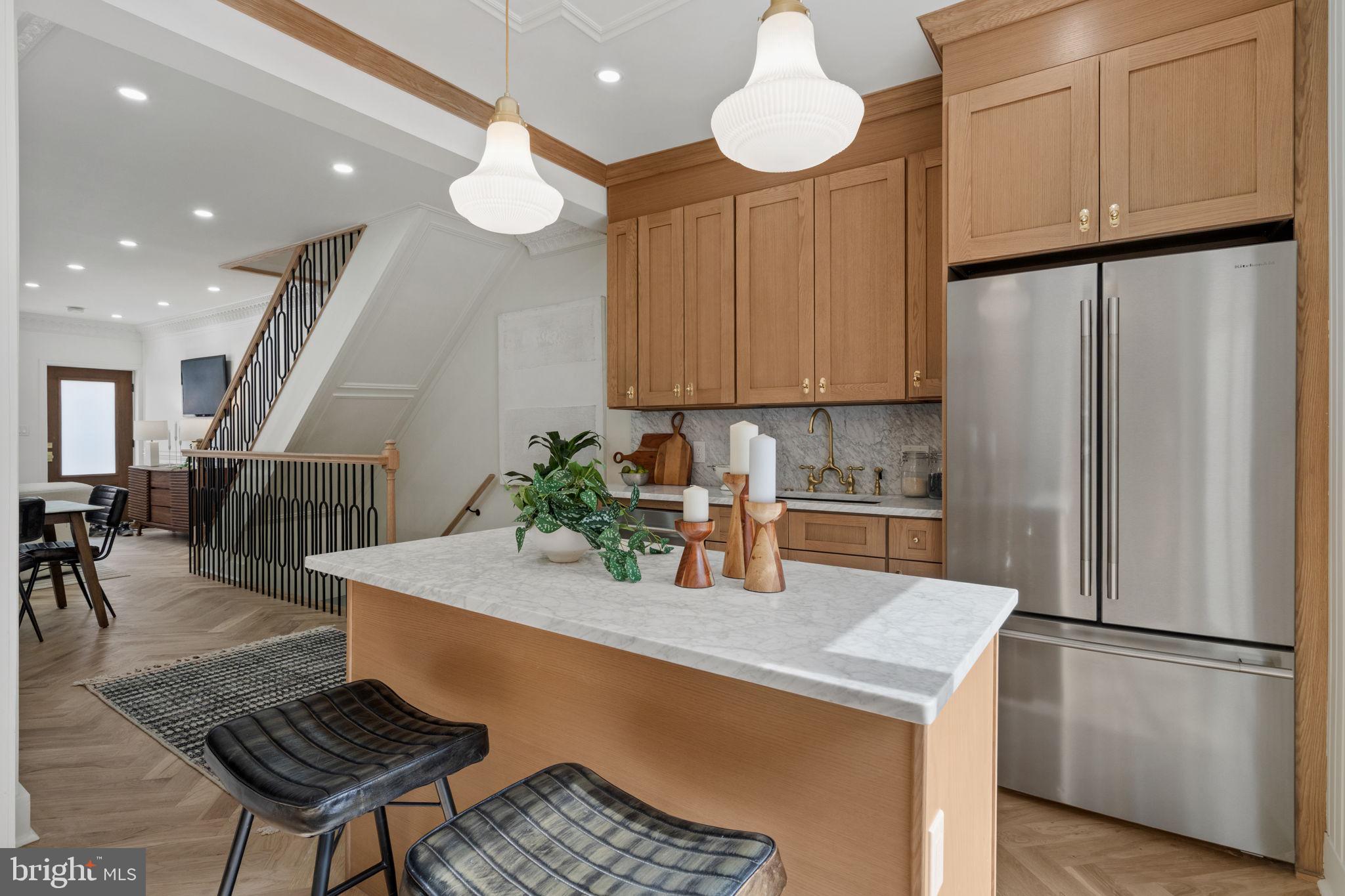 914 Fernon Street Philadelphia, PA 19148 - Photo 5 of 40 a kitchen with stainless steel appliances granite countertop a refrigerator a sink dishwasher a stove a dining table and chairs with wooden floor