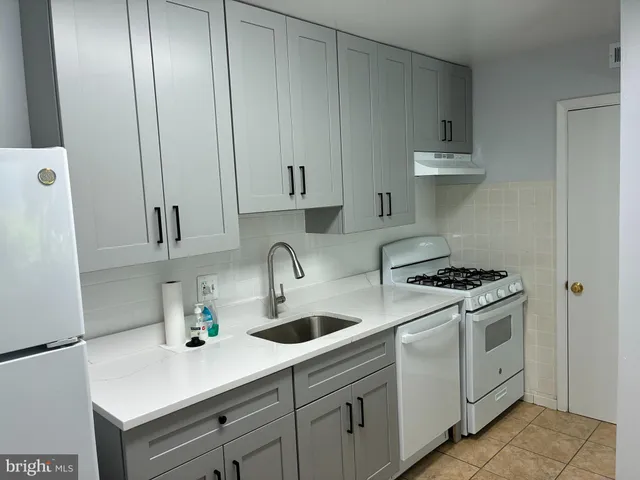 a kitchen with cabinets and appliances