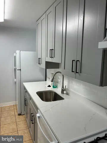 a kitchen with stainless steel appliances a sink a stove and refrigerator