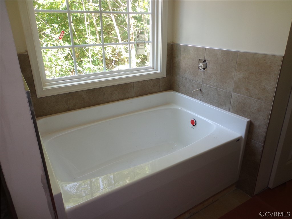 6010 Watch Harbour Road Midlothian, VA 23112 - Photo 7 of 30 a white bath tub sitting in a bathroom next to a window