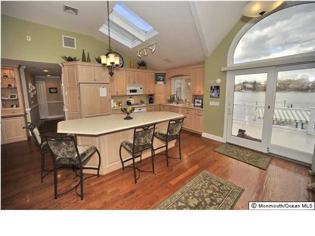 98 Meadow Point Road Point Pleasant, NJ 08742 - Photo 3 of 3 a living room with stainless steel appliances kitchen island granite countertop furniture and a dining table