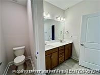 268 Brickhill Drive Raeford, NC 28376 - Photo 17 of 21 a bathroom with a sink a toilet and a mirror