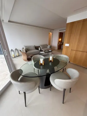 a living room with chairs and a table