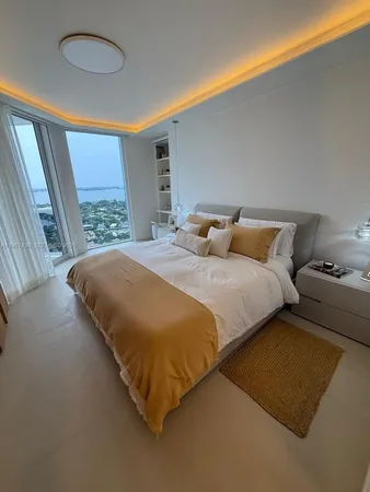 a bedroom with a bed and a night stand