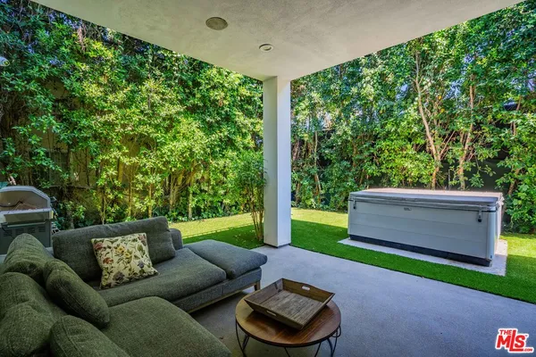 a house view with a garden and outdoor seating