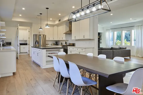 a large kitchen with a table and chairs