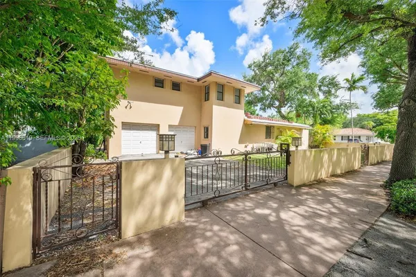 a view of a house with a wooden fence