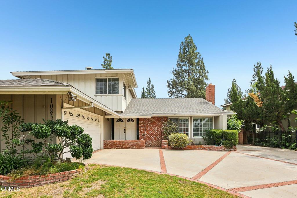 10856 Topeka Drive Porter Ranch, CA 91326 - Photo 4 of 40 a front view of a house with a yard