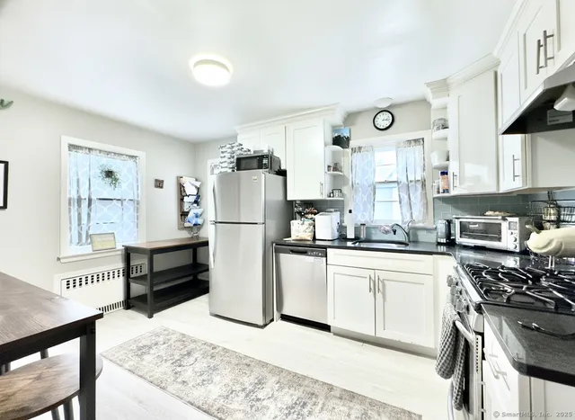 a kitchen with a stove a refrigerator and a stove top oven