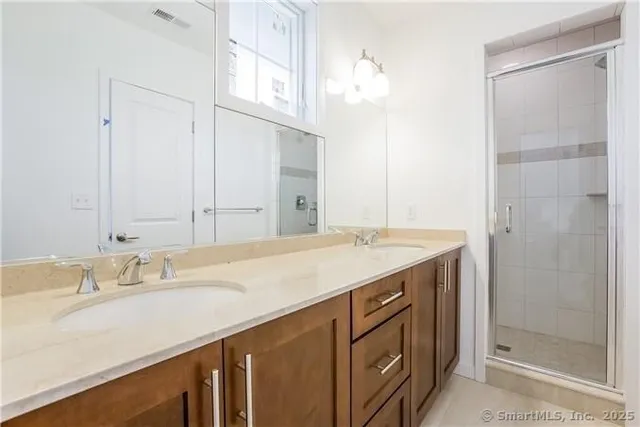 a bathroom with a sink double vanity and a mirror