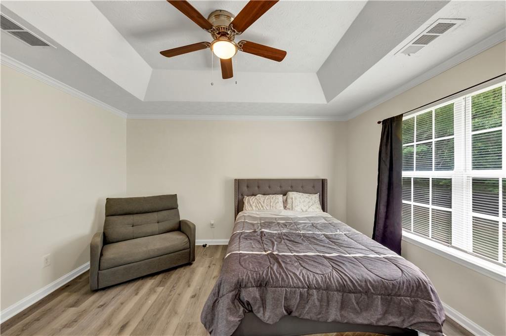 2880 Field Spring Drive Lithonia, GA 30058 - Photo 24 of 31 a bedroom with a bed and wooden floor