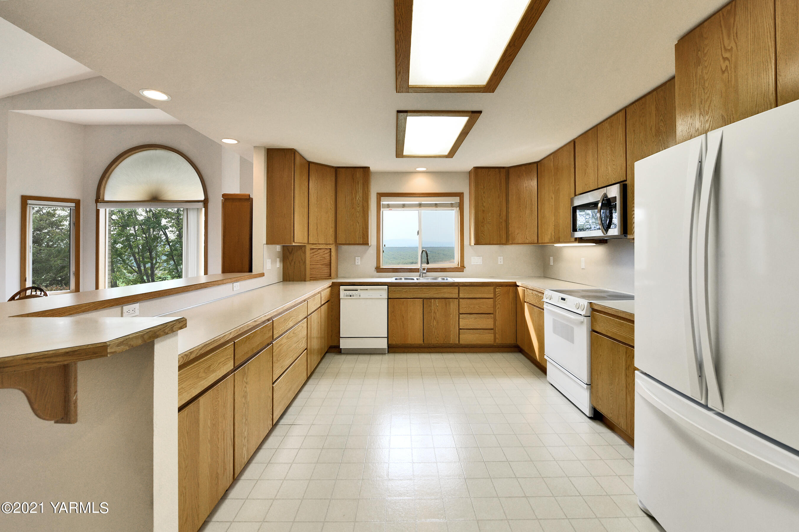 1511 Rosenkranz Road Tieton, WA 98947 - Photo 13 of 41 a kitchen with stainless steel appliances a refrigerator sink and cabinets
