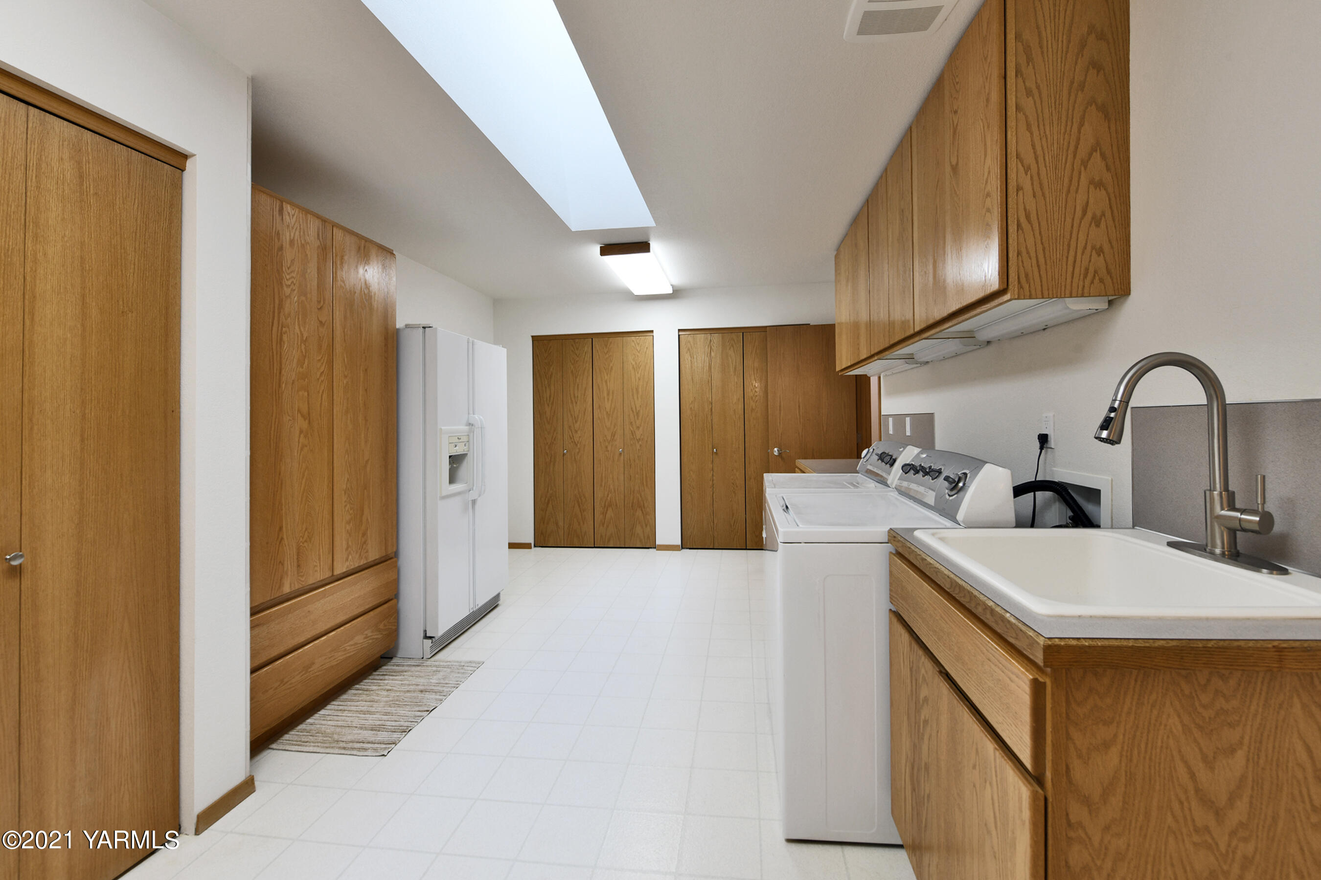1511 Rosenkranz Road Tieton, WA 98947 - Photo 25 of 41 a kitchen with a sink a refrigerator and cabinets