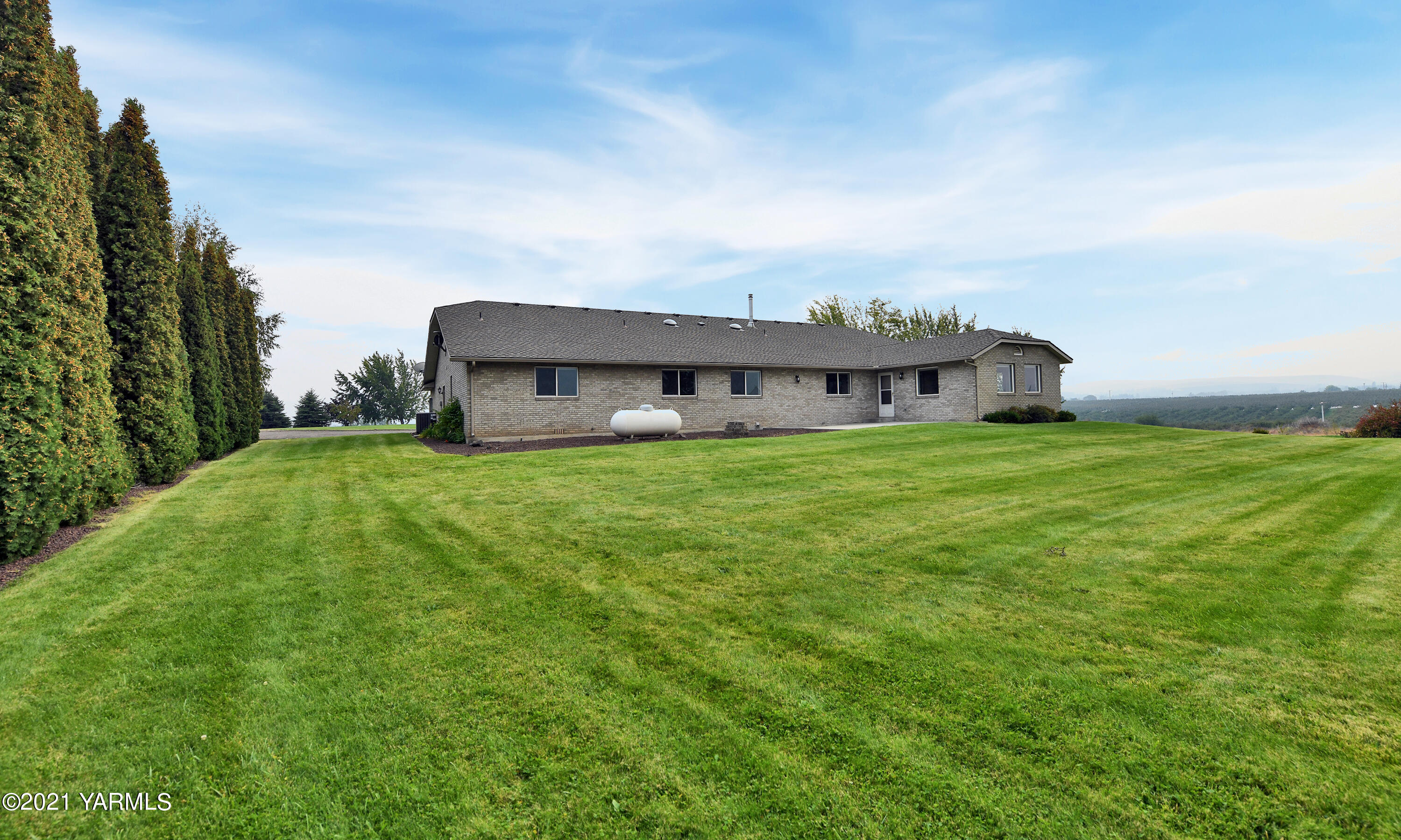 1511 Rosenkranz Road Tieton, WA 98947 - Photo 30 of 41 a view of a house with a big yard and large trees