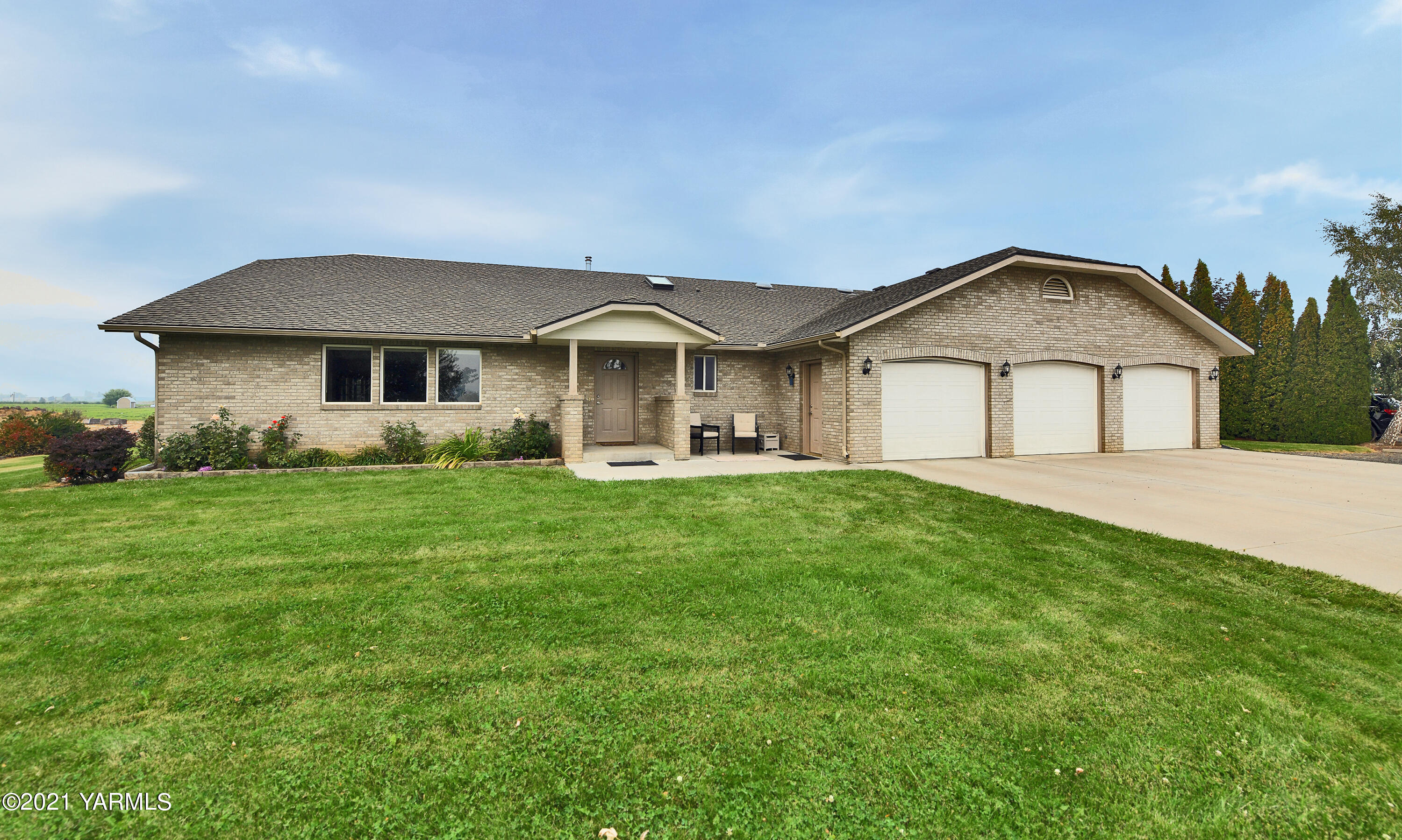 1511 Rosenkranz Road Tieton, WA 98947 - Photo 32 of 41 a front view of a house with a garden and trees