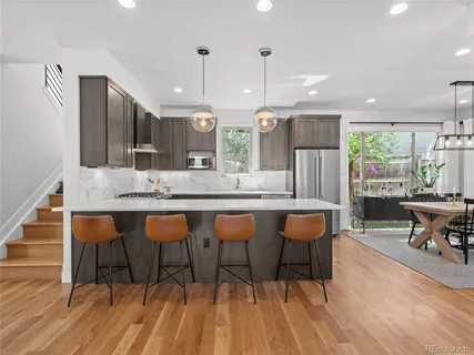 a large kitchen with a table and chairs