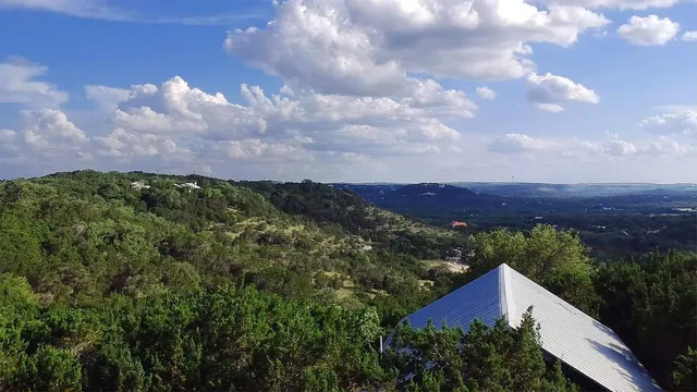 a view of house with a yard and a wooden fence