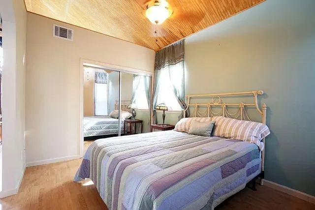 a bedroom with double bed and a window