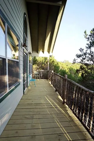 a view of a balcony with wooden floor