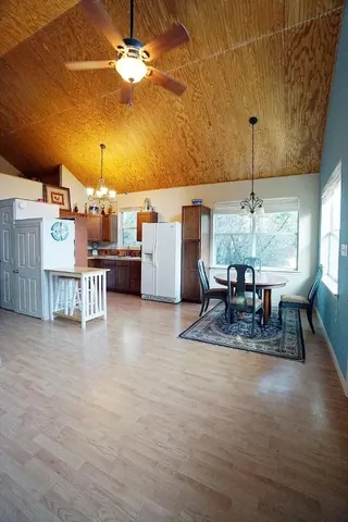 a dining room with furniture and a chandelier