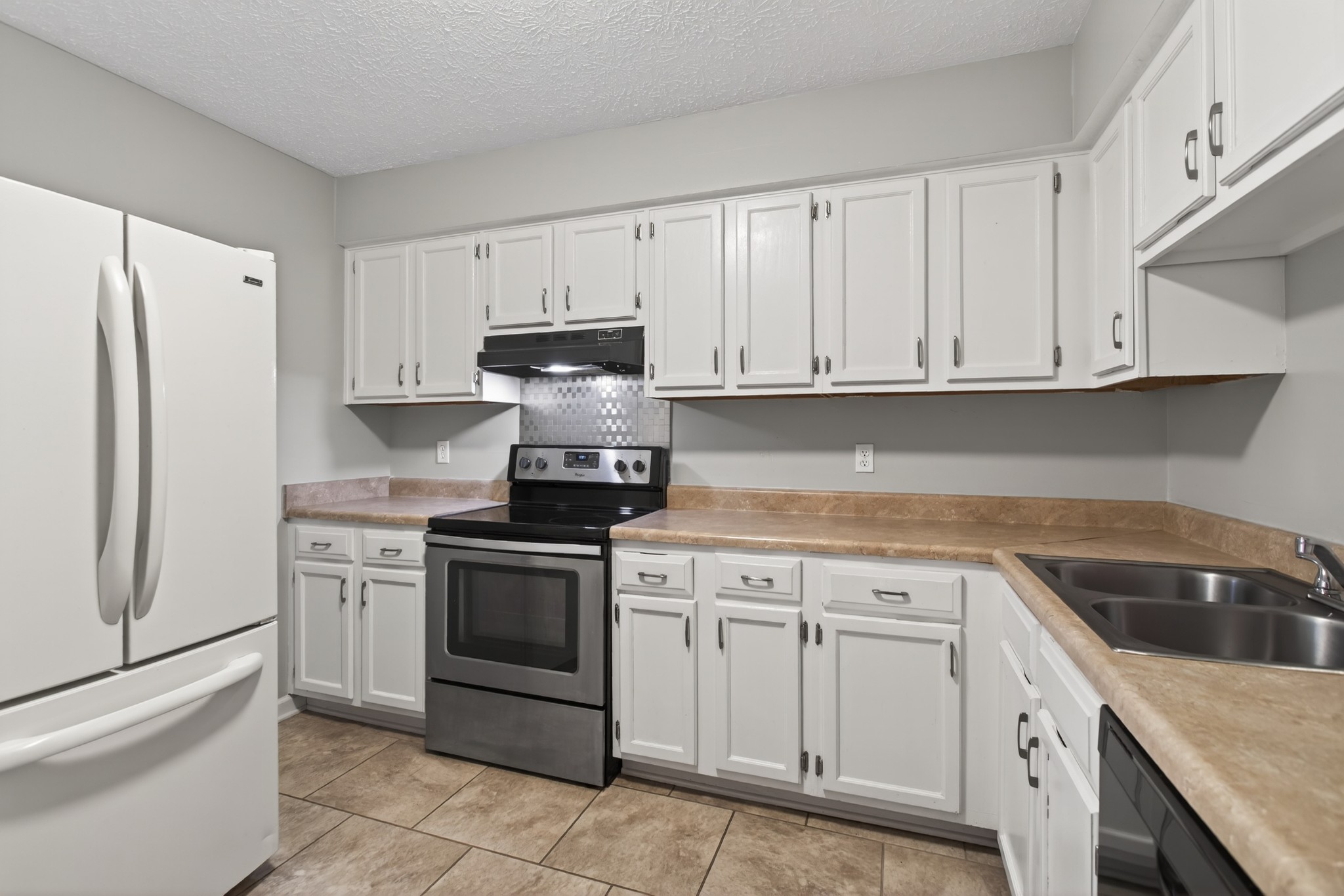 430 Walton Ferry Road, Unit 200 Hendersonville, TN 37075 - Photo 8 of 16 a kitchen with white cabinets and white appliances