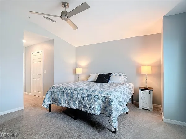 a bedroom with a bed and a lamp