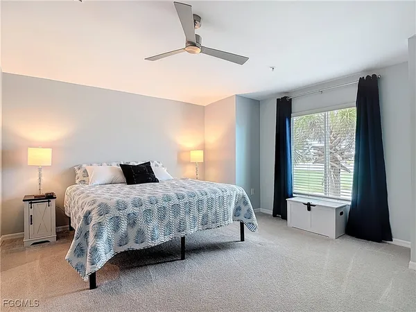 a spacious bedroom with a bed and a large window