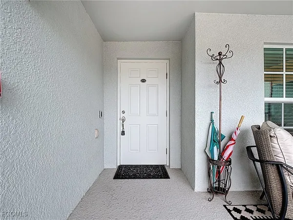a walk in closet with wooden floor