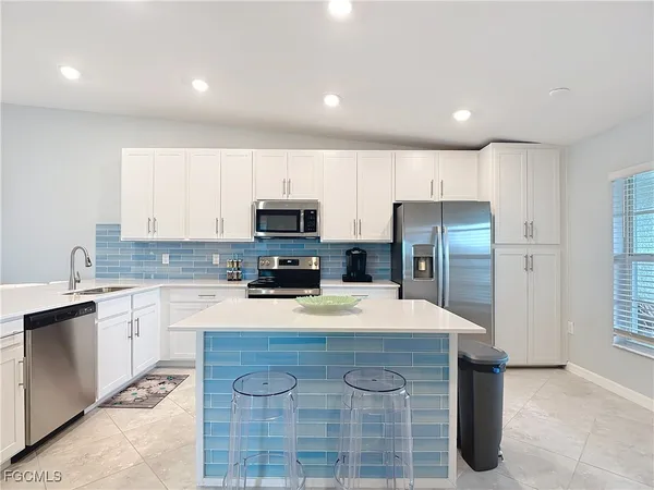 a kitchen with refrigerator cabinets and wooden floor