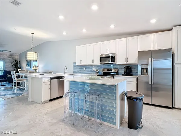 a kitchen with a sink cabinets and stainless steel appliances
