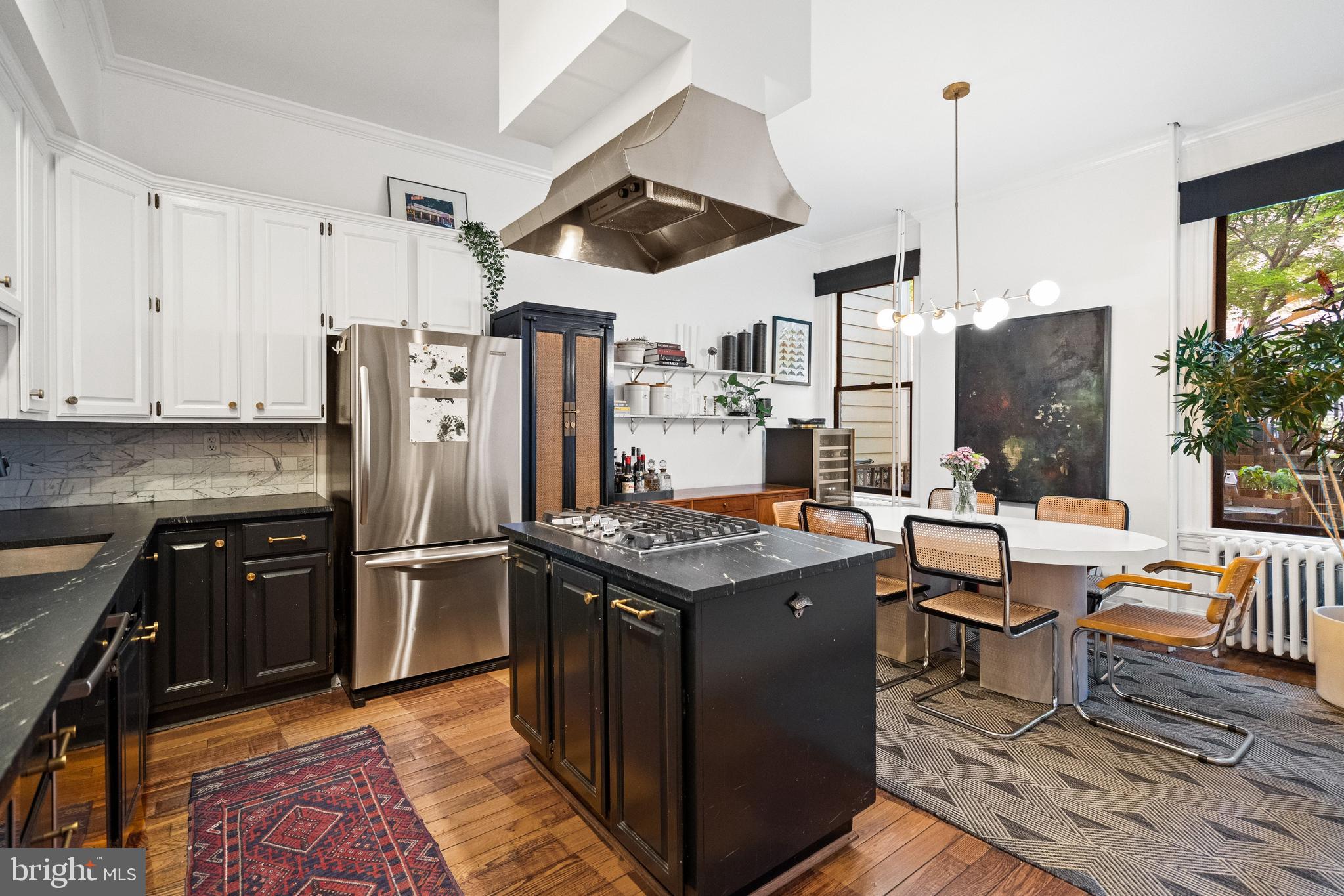 2026 15th Street Northwest Washington, DC 20009 - Photo 12 of 47 a kitchen with stainless steel appliances granite countertop a stove refrigerator and chairs