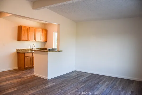 a view of kitchen with wooden floor and electronic appliances