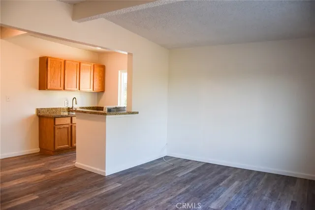 a view of kitchen with wooden floor and electronic appliances