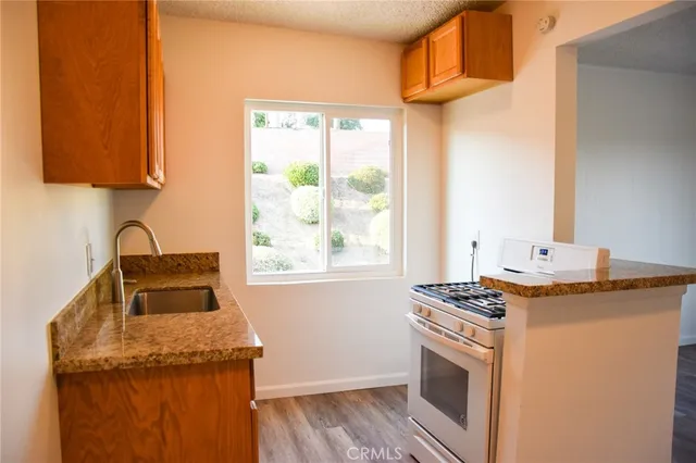 a kitchen with a sink a counter and a window