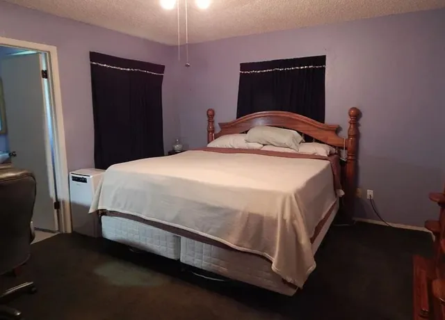 a bedroom with a bed and a mirror