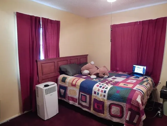 a bedroom with a bed and wooden closet