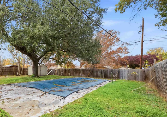 a view of a backyard with large trees