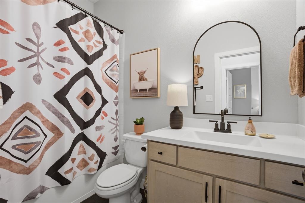 1632 Cotton Road Van Alstyne, TX 75495 - Photo 15 of 40 a bathroom with a toilet sink and mirror