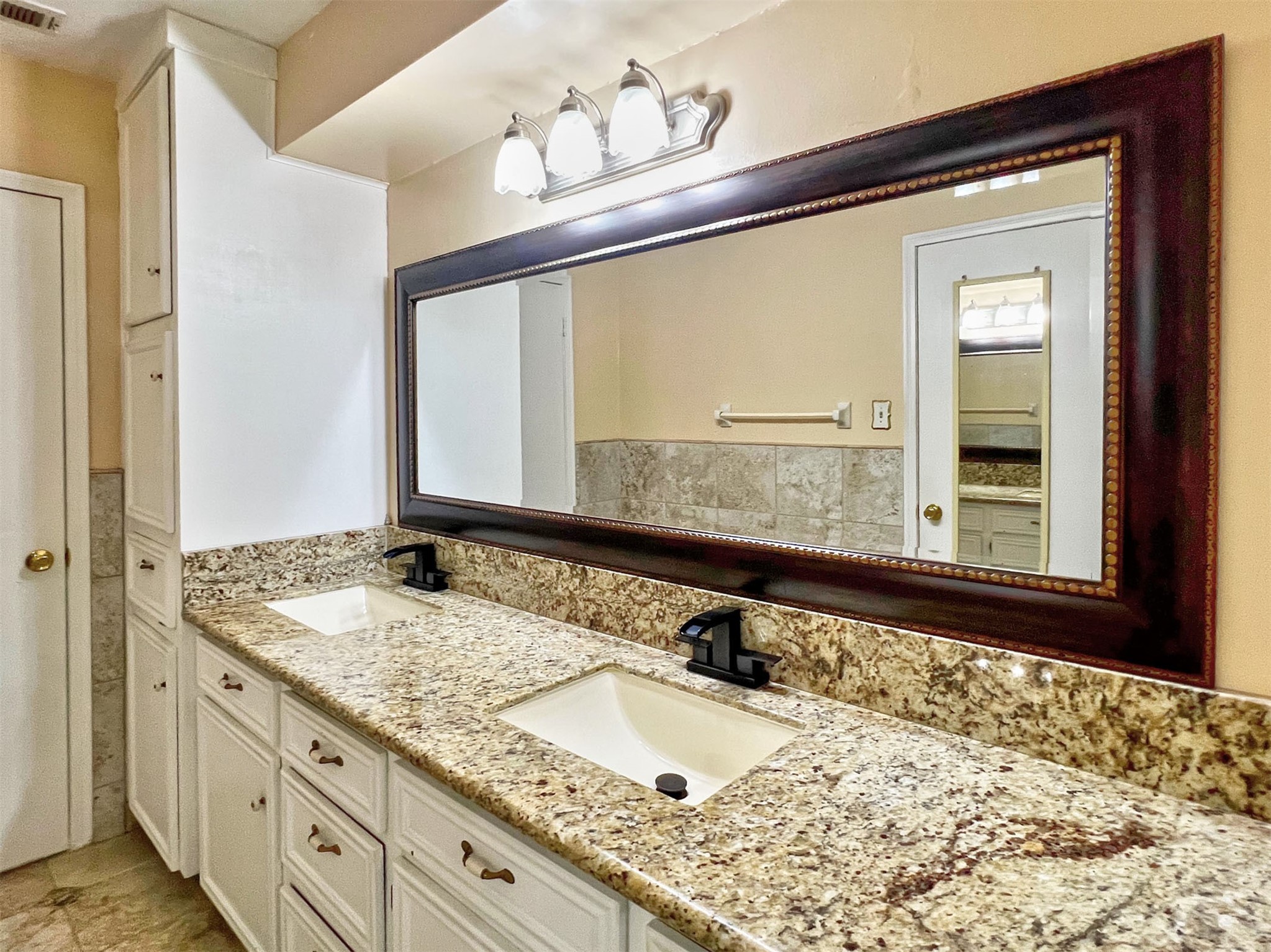 16902 Summit Oaks Lane Spring, TX 77379 - Photo 32 of 49 a bathroom with a granite countertop sink and a large mirror