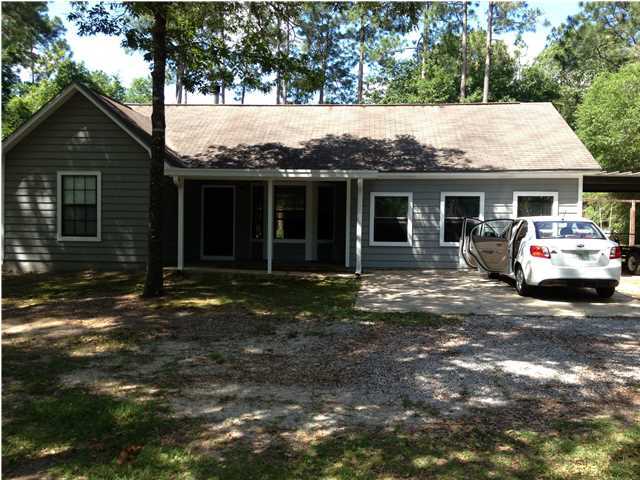 6178 Garden City Road Crestview, FL 32539 - Photo 2 of 14 a front view of a house with a garden
