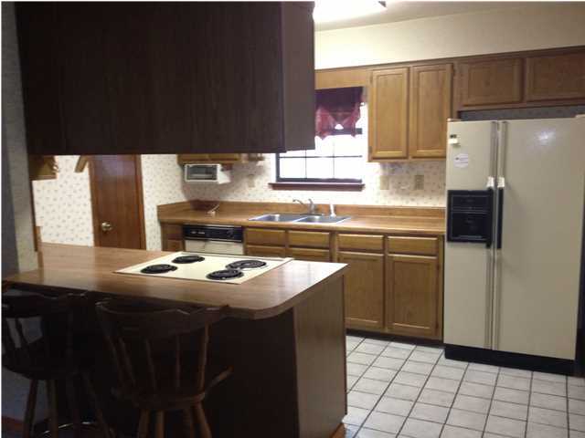 6178 Garden City Road Crestview, FL 32539 - Photo 11 of 14 a kitchen with stainless steel appliances a sink stove and refrigerator
