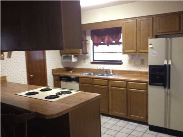 6178 Garden City Road Crestview, FL 32539 - Photo 10 of 14 a kitchen with stainless steel appliances a stove a sink and a refrigerator