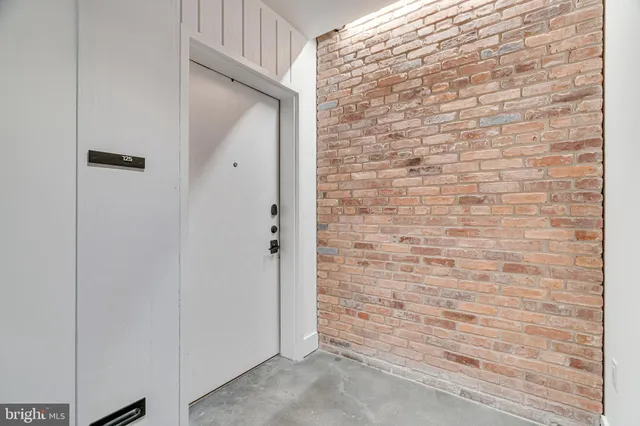 a view of a walk in closet with wooden floor and stairs