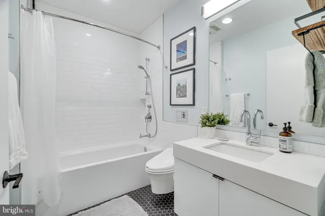 a bedroom with a bed and a lamp with the wooden floor