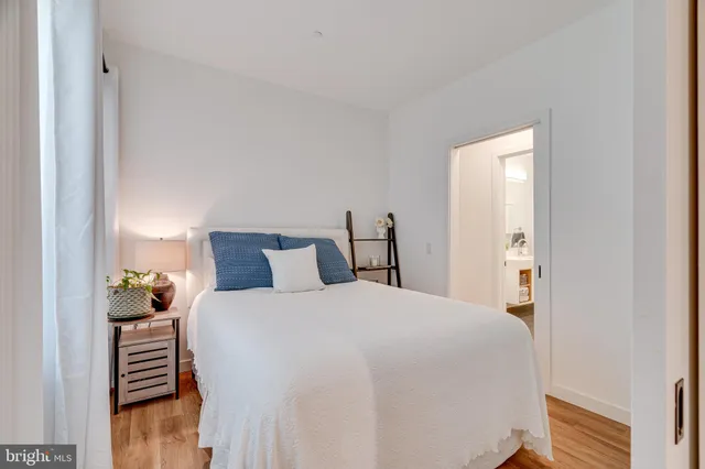 a bedroom with a bed and a large mirror