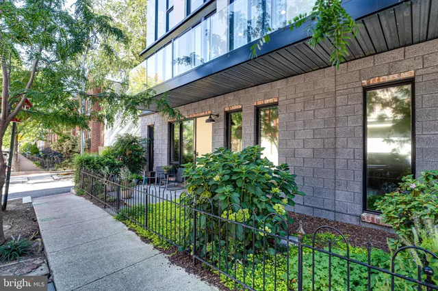 a view of a hallway with wooden floor and a floor to ceiling window
